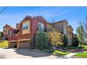 Beautiful residence showcasing a blend of stone and stucco, a balcony, and an attached garage with a paver driveway at 9588 Firenze Way, Highlands Ranch, CO 80126