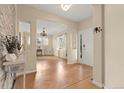 Inviting home foyer features stylish light colored hardwood floors and white trim at 22 Apache Plume St, Brighton, CO 80601
