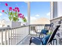 Inviting front porch featuring chairs, accent pillows, and decorative planters creating a relaxing outdoor seating area at 15833 Little Bluestem Rd, Monument, CO 80132