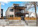Modern home boasts a brick and stucco facade with a rooftop deck and a fenced front yard at 1845 W 33Rd Ave, Denver, CO 80211