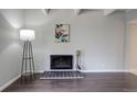 Living room showing fireplace with decoratively tiled hearth and modern floor lamp at 9995 E Harvard Ave # 155, Denver, CO 80231
