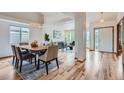 Spacious dining room featuring modern lighting, hardwood floors and seamless access to living areas at 5394 S Valdai Way, Aurora, CO 80015