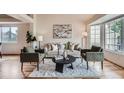 Comfortable living room with plush seating, soft rug, and bright windows is perfect for relaxation at 5394 S Valdai Way, Aurora, CO 80015
