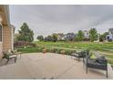 Relaxing outdoor patio with comfortable seating, overlooking a green lawn and scenic views of neighboring homes at 5394 S Valdai Way, Aurora, CO 80015