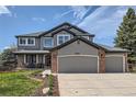 Charming two-story home with a three-car garage and a cozy covered front porch at 7411 S Curtice Ct, Littleton, CO 80120