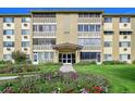 Apartment building with manicured front lawn and flower beds; 635 S Alton Way is visible above the entrance at 635 S Alton Way # 6A, Denver, CO 80247