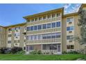 Multi-story apartment building with large windows, greenery, and visible architectural details at 635 S Alton Way # 6A, Denver, CO 80247