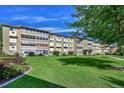 Well-maintained building exterior showcasing lush green lawn and blue sky at 635 S Alton Way # 6A, Denver, CO 80247