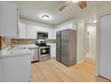 Efficient kitchen features stainless steel appliances, bright cabinets and a tiled backsplash at 635 S Alton Way # 6A, Denver, CO 80247