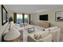 Cozy living room with a neutral color palette, balcony access, and modern decor at 635 S Alton Way # 6A, Denver, CO 80247