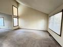 Spacious living room with vaulted ceilings, large windows and neutral walls offers a blank canvas at 17969 E Brown Pl, Aurora, CO 80013