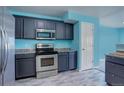 Modern kitchen with dark cabinets and stainless steel appliances at 1179 S Waco St # E, Aurora, CO 80017