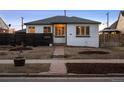 Inviting single-story home with a walkway and horizontal fence against a backdrop of twilight at 2855 Albion St, Denver, CO 80207