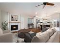 Inviting living room with a fireplace, hardwood floors, and an open-concept design at 9450 Troon Village Dr, Lone Tree, CO 80124