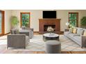 Cozy living room with a brick fireplace, large windows, and comfortable seating arrangement at 11824 E Basswood Ln, Franktown, CO 80116