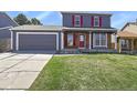 Beautiful two-story home with a well-manicured lawn, an attached garage, and colorful accents at 19828 E Brown Pl, Aurora, CO 80013