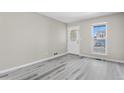Bright, open living room with sleek floors, a large window, and neutral wall colors at 19828 E Brown Pl, Aurora, CO 80013
