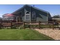 Expansive fenced backyard with a large wooden deck, ideal for outdoor relaxation and entertainment at 1998 E 100Th Pl, Thornton, CO 80229