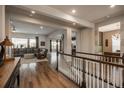 Open-concept foyer featuring hardwood floors, staircase, and seamless transition into the living areas at 23130 E Del Norte Cir, Aurora, CO 80016