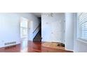 Inviting entryway with hardwood floors, a white door, and a view of the staircase at 2732 E 132Nd Pl, Thornton, CO 80241