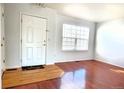 Bright living room featuring hardwood floors and a large window for ample natural light at 2732 E 132Nd Pl, Thornton, CO 80241