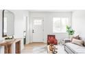 Bright living room boasts modern decor, stylish furniture, hardwood floors, and ample natural light at 4025 E Martin Luther King Jr, Denver, CO 80207