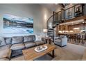 Comfortable living room with spiral staircase and open floorplan to the kitchen at 107 Ski Watch Rd # 32, Breckenridge, CO 80424