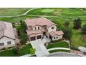 Expansive property boasts a terracotta roof, three-car garage, manicured lawn, and is located on a golf course at 16491 Fairway Dr, Commerce City, CO 80022