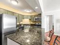 Well-equipped kitchen with granite countertops, stainless steel appliances, and ample storage space at 1301 Speer Blvd # 702, Denver, CO 80204