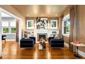 Bright living room featuring a fireplace, built-in shelving, and modern decor at 2604 Elm St, Denver, CO 80207