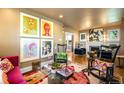 Eclectic living room featuring vibrant artwork, stylish furniture, and hardwood floors for a unique aesthetic at 2604 Elm St, Denver, CO 80207