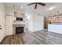 Living room with fireplace, wood-look floors, and kitchen views at 16312 E Fremont Ave # 2, Aurora, CO 80016