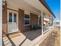 Inviting front porch featuring comfortable seating and decorative accents by the home's entrance at 10415 Owens Cir, Broomfield, CO 80021