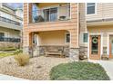 Inviting front porch with stone accents and seating area, leading to the entrance at 11250 Florence St # 21A, Commerce City, CO 80640
