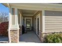 View of front porch entrance highlighting neutral siding, stone accents, and a spacious covered area at 13708 Legend Trl # 101, Broomfield, CO 80023