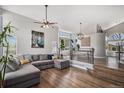 Bright living room featuring a large sectional sofa, high ceilings, and hardwood floors at 9195 Anasazi Indian Trl, Highlands Ranch, CO 80129