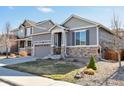 Beautiful gray single-Gathering home with stone veneer, two-car garage, and well-maintained lawn at 7426 Blue Water Ln, Castle Rock, CO 80108