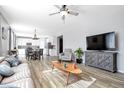 Inviting open concept living room with hardwood floors and a view of the dining area and kitchen at 7426 Blue Water Ln, Castle Rock, CO 80108