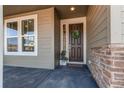 Inviting front door with a wreath, side window, and stone accents create a warm welcome at 17046 Desert Wine Trl, Parker, CO 80134