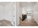 Bright entryway leads to spacious living areas with light wood floors at 9197 Ironwood St, Highlands Ranch, CO 80129