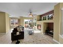 Bright living room with a cozy fireplace, neutral walls, and ample natural light at 5660 S Algonquian Way # A, Aurora, CO 80016