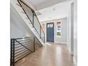 Inviting entryway with modern staircase, sleek metal railings, and abundant natural light at 6854 Carr St, Arvada, CO 80004