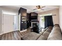 A modern living room featuring a fireplace, comfortable sectional sofa, and a balcony at 8500 E Jefferson Ave # 19B, Denver, CO 80237