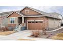 Inviting home featuring a brick facade, a manicured lawn, and a front yard rock garden at 8844 S Sicily Ct, Aurora, CO 80016