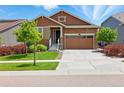 Charming single-Gathering home with a well-manicured lawn, stone accents, and a two-car garage at 8844 S Sicily Ct, Aurora, CO 80016