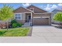 Charming single-Gathering home featuring stone accents, a two-car garage, and a well-manicured lawn at 8844 S Sicily Ct, Aurora, CO 80016