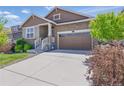 Charming two-story home featuring a stone facade, two-car garage, and well-maintained landscaping at 8844 S Sicily Ct, Aurora, CO 80016