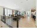 Open-concept living space with wood floors, large windows, and seamless indoor-outdoor flow at 8844 S Sicily Ct, Aurora, CO 80016