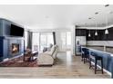 Bright and open living room featuring a fireplace, sliding glass doors, and recessed lighting at 8844 S Sicily Ct, Aurora, CO 80016