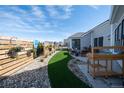 Backyard oasis with turf, stone, and a seating area perfect for outdoor entertaining at 367 Josef Cir, Fort Lupton, CO 80621
